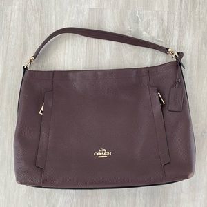 Gently used Coach shoulder bag with champagne hardware.